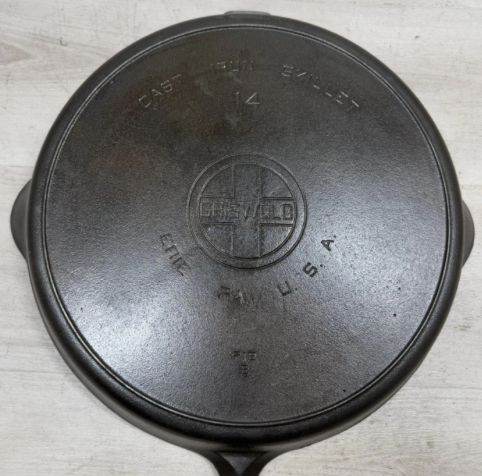 Bottom of Griswold number 14 large block logo EPU cast iron skillet with heat ring, pattern number 718. Noted to have a "slight wobble" (not uncommon with larger-sized pans, in particular). Sold for $575.